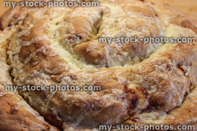 Stock image of homemade savoury povitica bread, coiled pizza bread with cheese topping