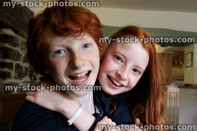 Stock image of happy brother and sister smiling, laughing, messing about and playing
