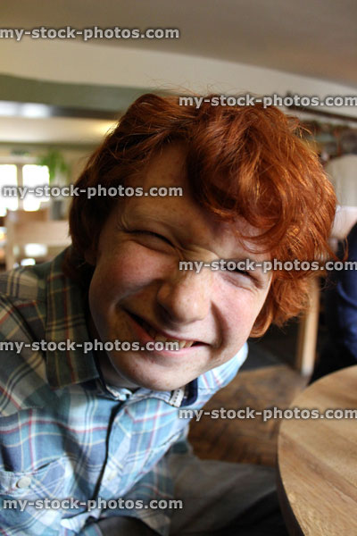 Stock image of teenage boy pulling a funny face, looking ugly and silly
