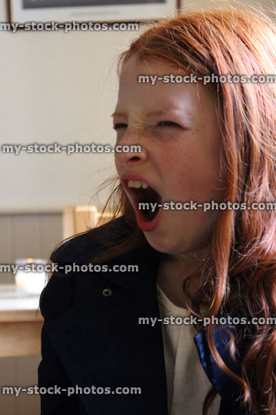 Stock image of girl feeling very tired and yawning to herself