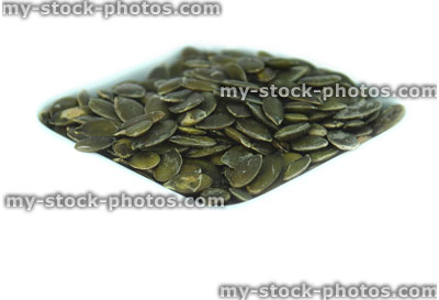 Stock image of pumpkin seeds / nuts in dish, high protein healthy snack food