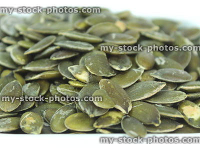 Stock image of pumpkin seeds / nuts in pile, high protein healthy snack food