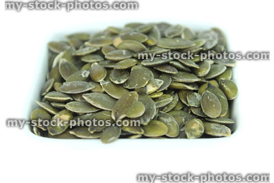 Stock image of pumpkin seeds in pile, high protein healthy snackfood, health benefits