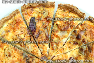 Stock image of sliced homemade bacon and egg quiche tart / savoury flan