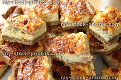 Stock image of slices of homemade bacon and egg quiche tart / savoury flan