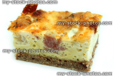 Stock image of slice of homemade bacon and egg quiche tart / savoury flan