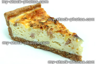 Stock image of slice of homemade bacon and egg quiche tart / savoury flan