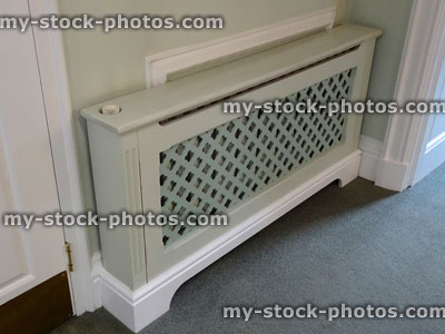 Stock image of wooden radiator cover / cabinet, fretwork grille painted MDF