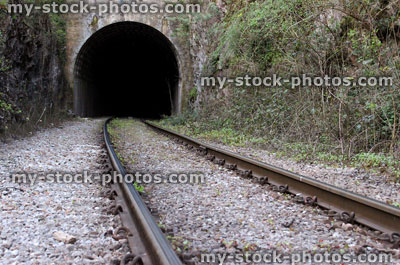 Stock image of rail road / railway train track disappearing into tunnel