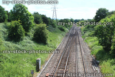 Stock image of railway line / railroad tracks heading through countryside in summer