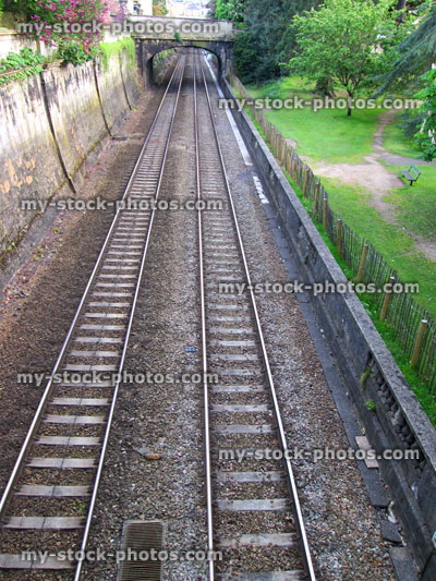 Stock image of railway line tracks stretching into the distance, bridge