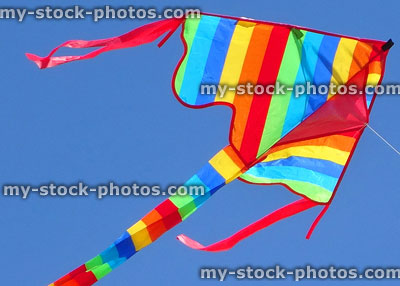 Stock image of kite shaped as arrowhead with rainbow stripe pattern