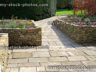Stock image of raised garden beds with flagstone paving patio, wheelchair friendly