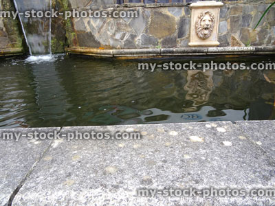 Stock image of rectangular raised formal pond, stone wall, fountain, waterfall / water feature