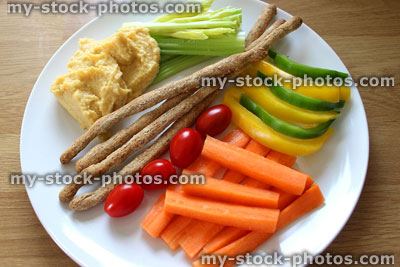 Stock image of healthy lunch, raw vegetables, wholemeal breadsticks, hummus, carrots, celery, peppers