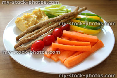 Stock image of healthy lunch, raw vegetables, breadsticks, hummus, carrots, tomatoes, celery, peppers