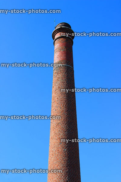 Stock image of tall red brick chimney / smoke stack again sky 