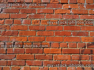 Stock image of plain, old red-brick wall with crumbling brickwork / mortar