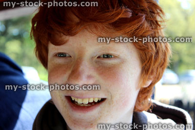 Stock image of happy boy with red hair smiling and laughing