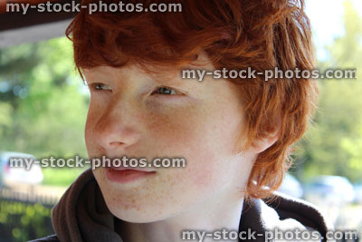 Stock image of happy boy with red hair thinking quiet thoughts