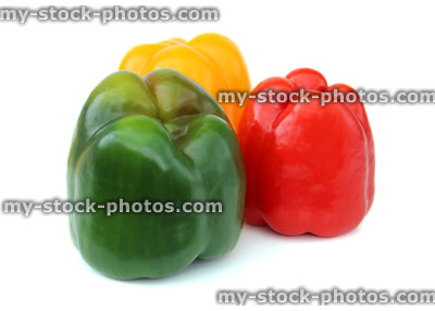 Stock image of red, yellow and green traffic light peppers group, white background