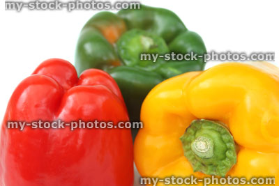 Stock image of red, yellow, green peppers, traffic light capsicums, white background, bright colours