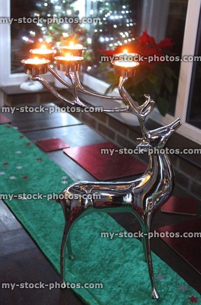 Stock image of silver reindeer stag with antlers of tealight candles