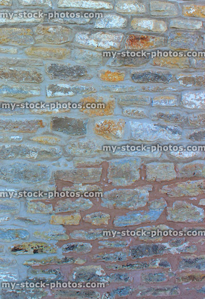 Stock image of repointed cobblestone wall on exterior of old house