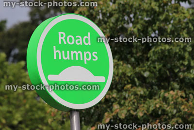 Stock image of road humps sign, circular green sign in car park