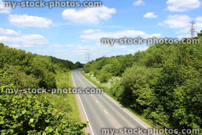 Stock image of straight tarmac road / highway heading through countryside landscape
