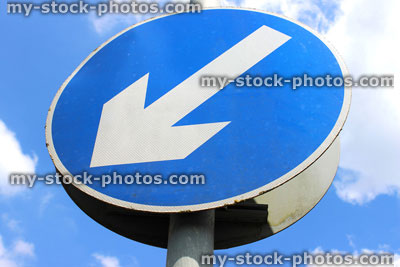 Stock image of road sign, white arrow on blue circle, 'Keep Left' sign