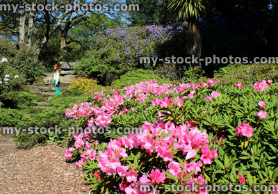Stock image of child walking through rock gardens with flowers, plants, trees, path