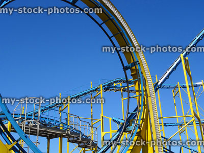 Stock image of yellow and blue rollercoaster loop, theme park / funfair