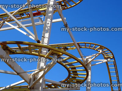 Stock image of curving metal railroad track on rollercoaster funfair ride
