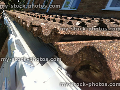 Stock image of roof tiles with new white UPVC plastic gutter