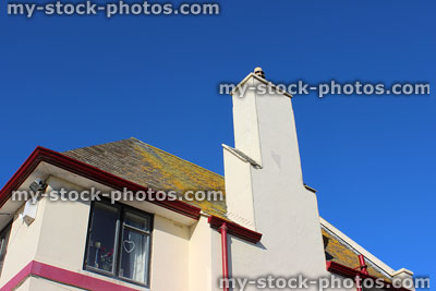 Stock image of slate roof, roofing tiles covered with lichen / moss