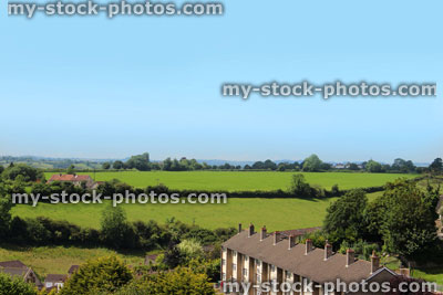 Stock image of countryside view with row of modern houses / rooftops, workers cottages