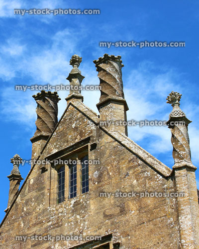 Stock image of ornate chimney stacks on old slate roof