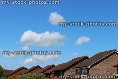 Stock image of tiled rooftops of modern, generic red brick houses