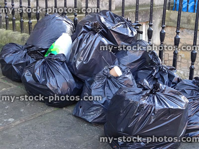 Stock image of black plastic rubbish bags / bin liners on doorstep