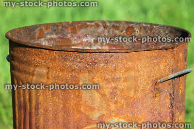 Stock image of rusty garden waste incinerator bin, on lawn grass