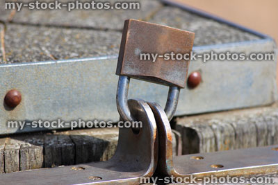 Stock image of rusty locked security padlock locking metal gate together