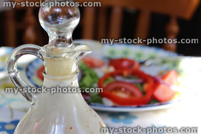 Stock image of homemade salad dressing in glass vinaigrette bottle
