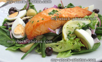 Stock image of pan fried salmon nicoise meal, salad, eggs, lemon