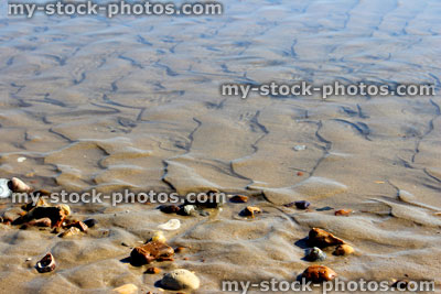 Stock image of patterns in sand, on beach, caused by sea