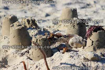 Stock image of sandcastles and seaweed, seaside bucket and spade method