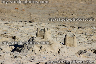 Stock image of sandcastle mound with bucket and spade castle turrets