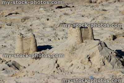 Stock image of seaside sandcastles on sand mound, beach summer holiday scene