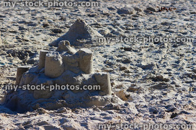 Stock image of children's sandcastles at sandy beach / seaside, summer holiday