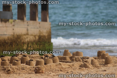 Stock image of sandcastles on beach, sand castles made on seaside holiday